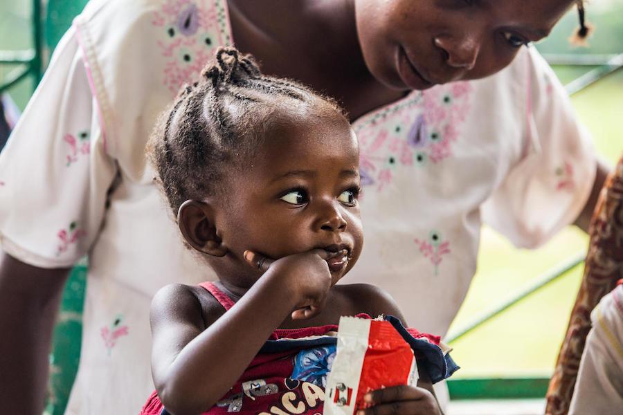 A baby girl eats Ready-to-Use Therapeutic Food provided by UNICEF and partners at a health center in Kananga, Kasai-Occidental province, Democratic Republic of the Congo, in October 2018.