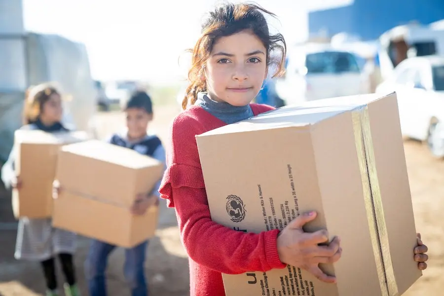 Reem, 10 years, holds her winter clothing kit. She has five sisters and two brothers – between 2 and 15 years. Her family are Syrian refugees and came to Jordan six years ago. She has just received her winter clothing kit from UNICEF and its partner Matee Reem, 10 years, holds her winter clothing kit. She has five sisters and two brothers – between 2 and 15 years. Her family are Syrian refugees and came to Jordan six years ago. She has just received her winter clothing kit from UNICEF and its partner Matee