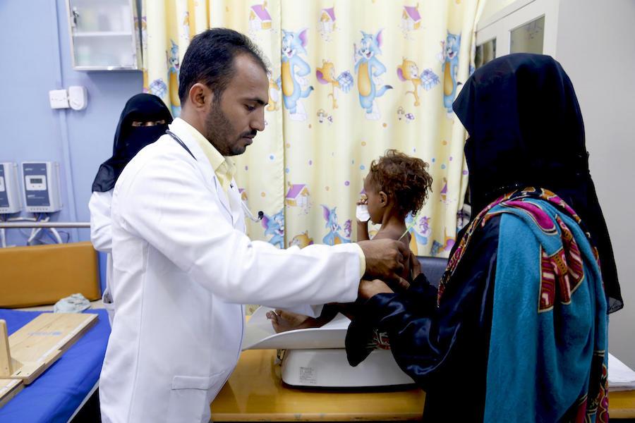 Dr. Waleed Ibrahim treats acutely malnourished children at the UNICEF-supported Therapeutic Feeding Center of Al-Zaidiah in Yemen.