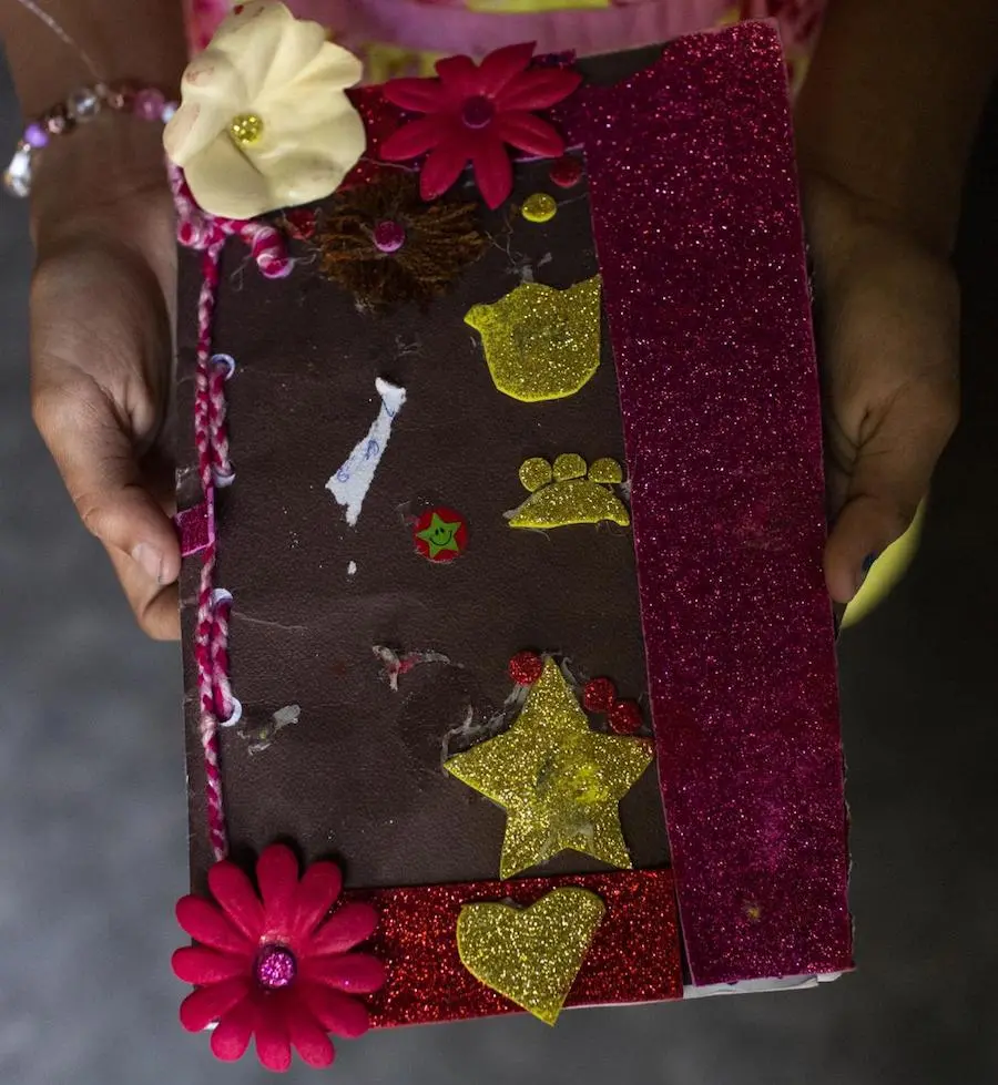 At a shelter for asylum seekers in Tapachula, Mexico in January 2019, Jennifer, 10, holds a diary she made in Guatemala while traveling from Honduras. At a shelter for asylum seekers in Tapachula, Mexico in January 2019, Jennifer, 10, holds a diary she made in Guatemala while traveling from Honduras.