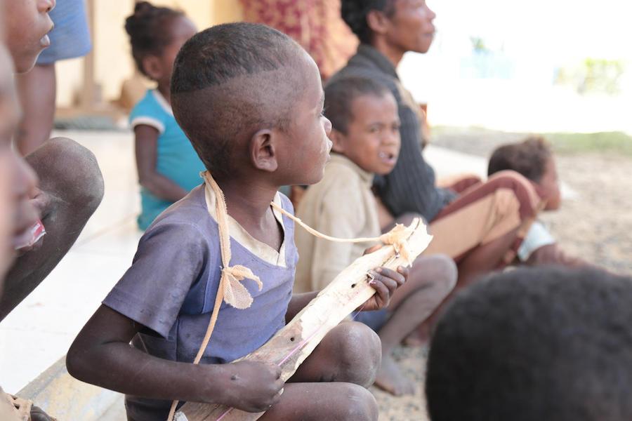 Bolo created his own toy, a music instrument, while waiting for his turn at the UNICEF-supported health center in Tsiombe, Madagascar in November 2018. 