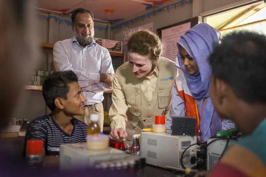 On 25 February 2019 in Bangladesh, (back left) Dr. Ahmed Al Meraikhi, UN Secretary General Humanitarian Envoy and (centre) UNICEF Executive Director Henrietta H. Fore visit the World Vision multi-purpose adolescent centre in Tenkali Rohingya refugee camp. UNICEF Executive Director Henrietta H. Fore observes adolescents learning cellphone repair in a UNICEF-supported program at Tenkali Rohingya refugee camp in Cox's Bazar, Bangladesh in February 2019.