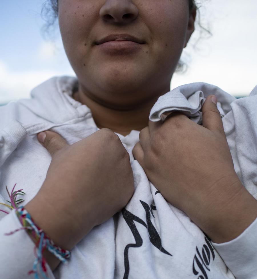 At a shelter for unaccompanied migrant adolescents in Tijuana, Mexico in February 2019, Kylie, 15, holds a T-shirt she won in a dance competition.