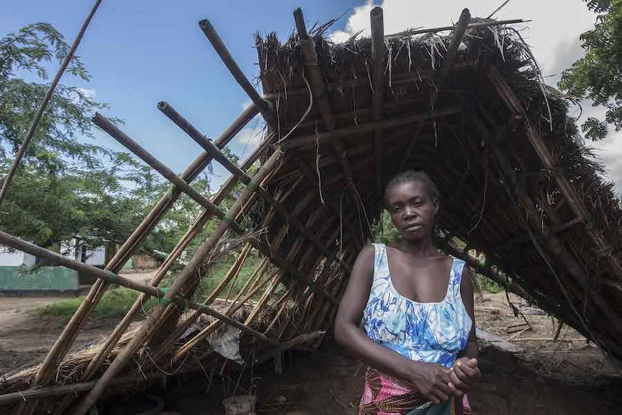 Having lost everything in Cyclone Idai, Anne stands near the wreckage of her former home. It will cost 30,000 kwacha [US $41.46] to rebuild.