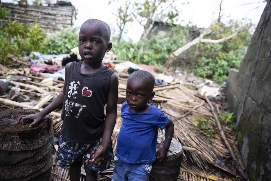 On 21 March 2019 in Mozambique, Manuel Jose Matapa and his brother Fransisco Jose Matapa stand next to the rubble that used to be there house in Beira. Their house was destroyed during Cyclone Idai in Beira, Mozambique. © UNICEF/UN0291165/de Wet AFP-Servi On 21 March 2019 in Mozambique, Manuel Jose Matapa and his brother Fransisco Jose Matapa stand next to the rubble that used to be there house in Beira. Their house was destroyed during Cyclone Idai in Beira, Mozambique. © UNICEF/UN0291165/de Wet AFP-Servi