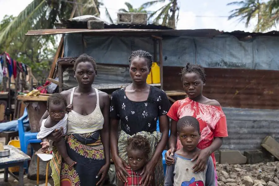 Anna Francesco holds her daughter Tina Fransesco, Clara Fransesco, Tija Fransesco, (bottom row) Regina Francesco and Emmanuel Francesco stands in front of a temporary shelter that they built in Beira. Their house was destroyed during Cyclone Idai. This f Anna Francesco holds her daughter Tina Fransesco, Clara Fransesco, Tija Fransesco, (bottom row) Regina Francesco and Emmanuel Francesco stands in front of a temporary shelter that they built in Beira. Their house was destroyed during Cyclone Idai. This f