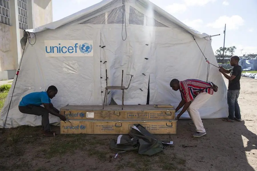 men set up a UNICEF distribution tent at the Samora Michel High School in Beira. This tent will be used to distribute needed supplies to people that has been displaced by the floods caused by Cyclone Idai. men set up a UNICEF distribution tent at the Samora Michel High School in Beira. This tent will be used to distribute needed supplies to people that has been displaced by the floods caused by Cyclone Idai.