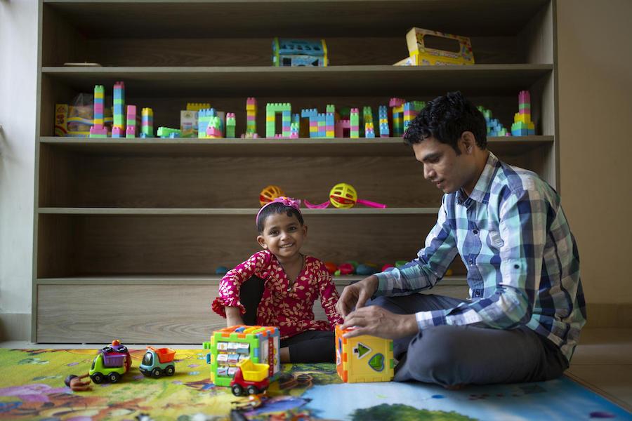 Jamal Hossain, 26, plays with his daughter Jui, 30 months, at the UNICEF-supported day care center at Northern Tosrifa Group garment factory where he works in Gazipur, outside Dhaka, Bangladesh.