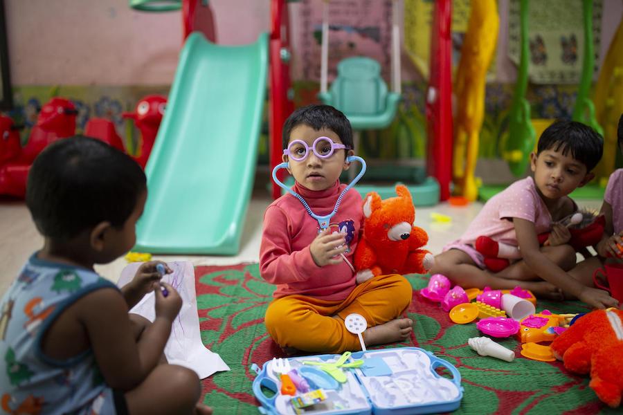 Jisha, 3, years play with a toy stethoscope and medical kit at at the Early Childhood Development (ECD) day care centre located on the Fakir Fashion Ltd. factory where both her parents work in Narayangonj, outside Dhaka, Bangladesh on December 10, 2018.