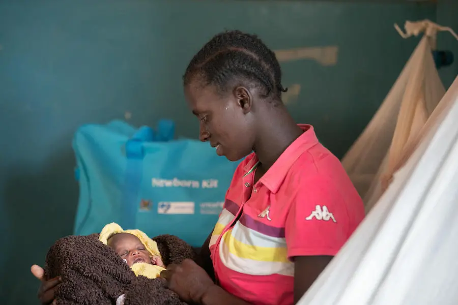 Longom Esther holds her newborn at Kaabong Hospital in northern Uganda on April 3, 2019. She received a newborn care kit provided by UNICEF with funding from KOICA. Longom Esther holds her newborn at Kaabong Hospital in northern Uganda on April 3, 2019. She received a newborn care kit provided by UNICEF with funding from KOICA.