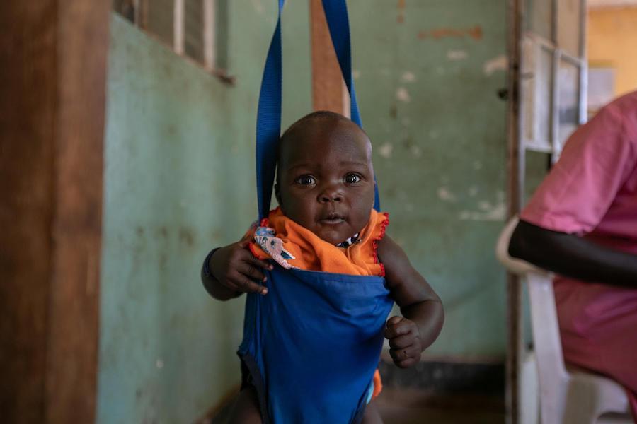 A baby is weighed before immunization at the UNICEF-supported Karenga HC IV in northern Uganda's Kaabong District on April 4, 2019.
