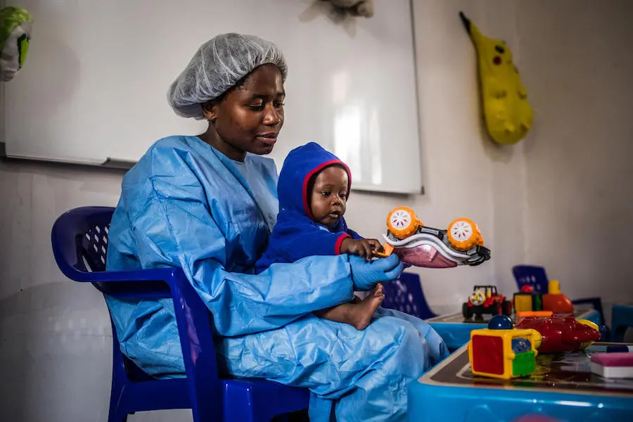 Ruth Lafleussante plays with Christ-Vie, 7 months, inside the UNICEF-supported Ebola nursery for babies and young children affected by the virus in Butembo, North Kivu, Democratic Republic of Congo, 23 March 2019. Ruth Lafleussante plays with Christ-Vie, 7 months, inside the UNICEF-supported Ebola nursery for babies and young children affected by the virus in Butembo, North Kivu, Democratic Republic of Congo, 23 March 2019.