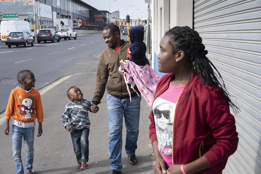 Dieu-Merci Matala, 44, walks home from the park with his children in Maitland, Cape Town, South Africa in May 2019.