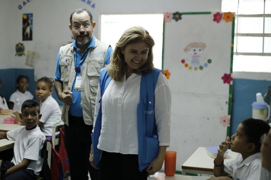 On June 4, 2019, UNICEF Director of Communication Paloma Escudero (center) and UNICEF Education Officer Dario Moreno meet with students at a UNICEF-supported school in Barrio Union, Petare, on the outskirts of Caracas, Venezuela. 