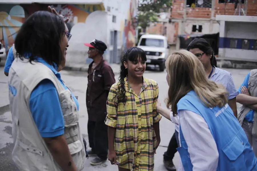 On June 4, 2019, Naibeth, 13 (center) meets with UNICEF staff near one of UNICEF's child protection centers in Caracas, Venezuela. On June 4, 2019, Naibeth, 13 (center) meets with UNICEF staff near one of UNICEF's child protection centers in Caracas, Venezuela.