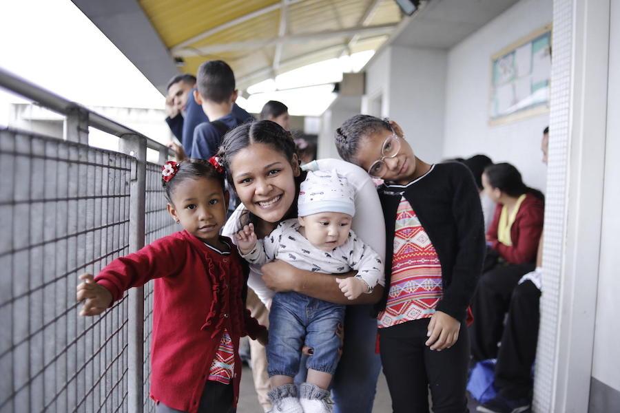 Children under age 5 and pregnant women wait to be immunized against yellow fever at the Urban Ambulatory Jose Maria Vargas. a UNICEF-supported health center in las Minas de Baruta, Caracas, in June 2019. 