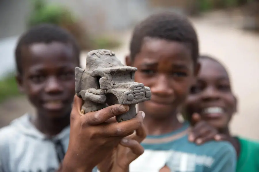 In April 2019, a boy made a truck out of clay at a school being used to shelter people displaced by Cyclone Idai in Beira, Mozambique.