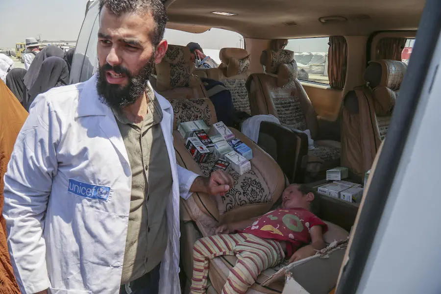 In Al-Hol camp northeast Syria, a child is examined by a health worker from a UNICEF-supported mobile health unit in July 2019.