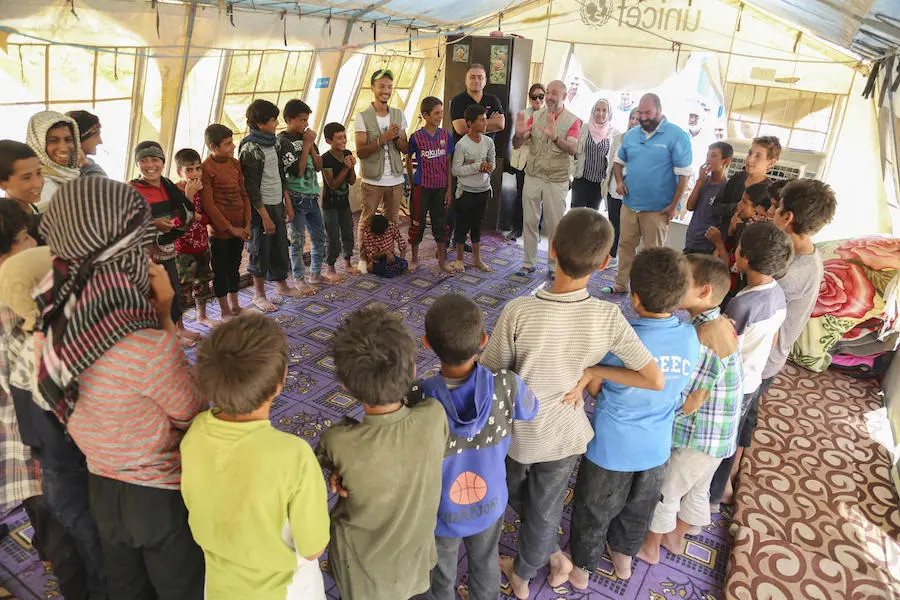On a visit to Al-Hol camp in northeast Syria in July 2019, UNICEF Syria Representative Fran Esquiza led a cooperative game for a group of displaced children. 