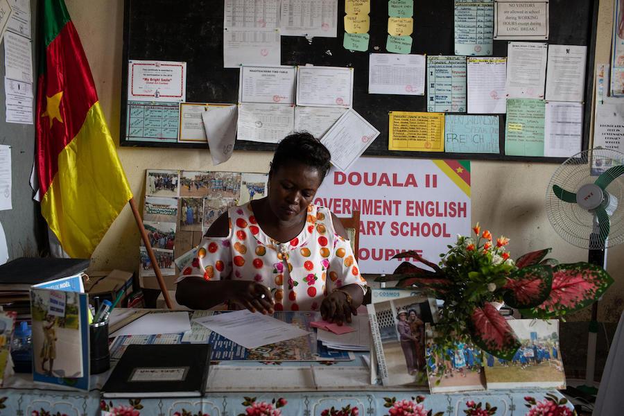 Ms. Delphine Bikajuri, Principal of GEPS Youpwe, a UNICEF-supported government primary school, at her desk in her office in Douala, Cameroon on 21 May 2019.