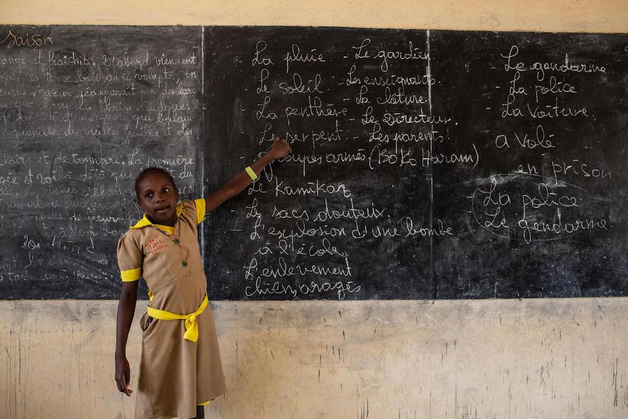 A student goes over blackboard notes for a class in emergency preparedness at a school in Baigaï, a village near the Nigerian border, Far North Region, Cameroon on 26 May 2019. 