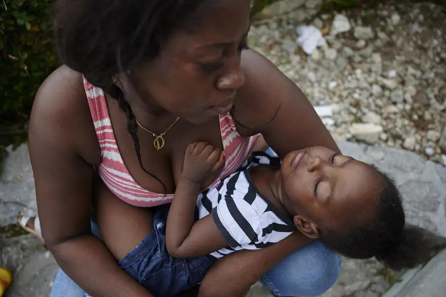 On 8 September 2019 in Bahamas, Joochim Maseline holds Stacy, her 2-year-old daughter, at St. Francis Church in Marsh Harbour in Abaco Island where they are sheltering temporarily. Their home was completely destroyed by the storm. On 8 September 2019 in Bahamas, Joochim Maseline holds Stacy, her 2-year-old daughter, at St. Francis Church in Marsh Harbour in Abaco Island where they are sheltering temporarily. Their home was completely destroyed by the storm.