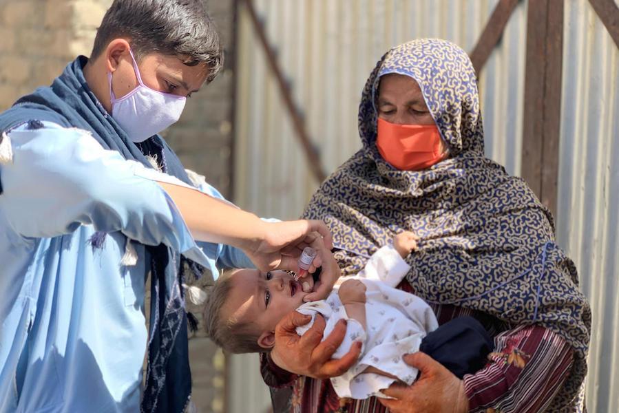 A 1-year old child receives the polio vaccine in the Spin Boldak district of Kandahar province during a UNICEF-supported vaccination campaign in September 2020 that targeted over 6 million children under age 5. 