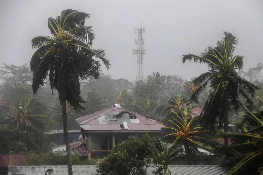 View of a house with a damaged roof and palm trees blowing in the wind as Hurricane Eta makes landfall in Bilwi, Puerto Cabezas, Nicaragua, on November 3, 2020. View of a house with a damaged roof and palm trees blowing in the wind as Hurricane Eta makes landfall in Bilwi, Puerto Cabezas, Nicaragua, on November 3, 2020.