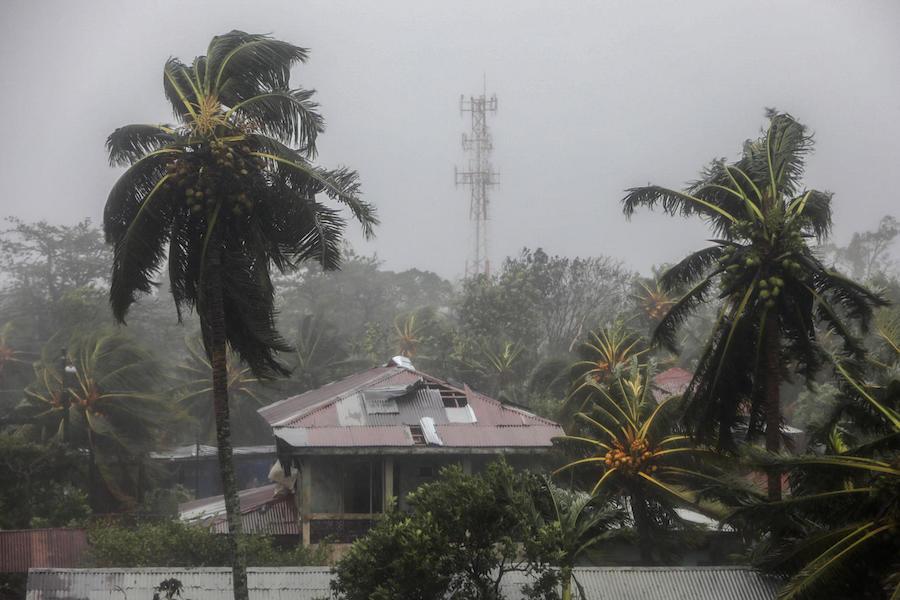 View of a house with a damaged roof and palm trees blowing in the wind as Hurricane Eta makes landfall in Bilwi, Puerto Cabezas, Nicaragua, on November 3, 2020. 