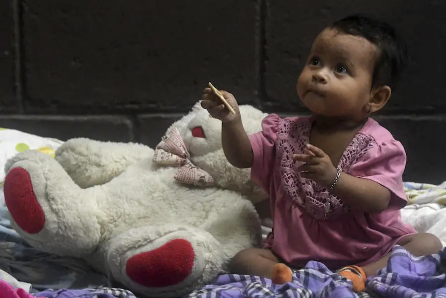 A baby is seen in a temporary shelter during heavy winds caused by Eta Hurricane at the Polideportivo in Tela, 300 km northern Tegucigalpa, on November 3, 2020. A baby is seen in a temporary shelter during heavy winds caused by Eta Hurricane at the Polideportivo in Tela, 300 km northern Tegucigalpa, on November 3, 2020.