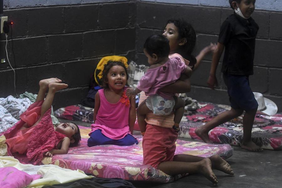 hildren play in a temporary shelter during heavy winds caused by Eta Hurricane at the Polideportivo in Tela, 300 km northern Tegucigalpa, on November 3, 2020.