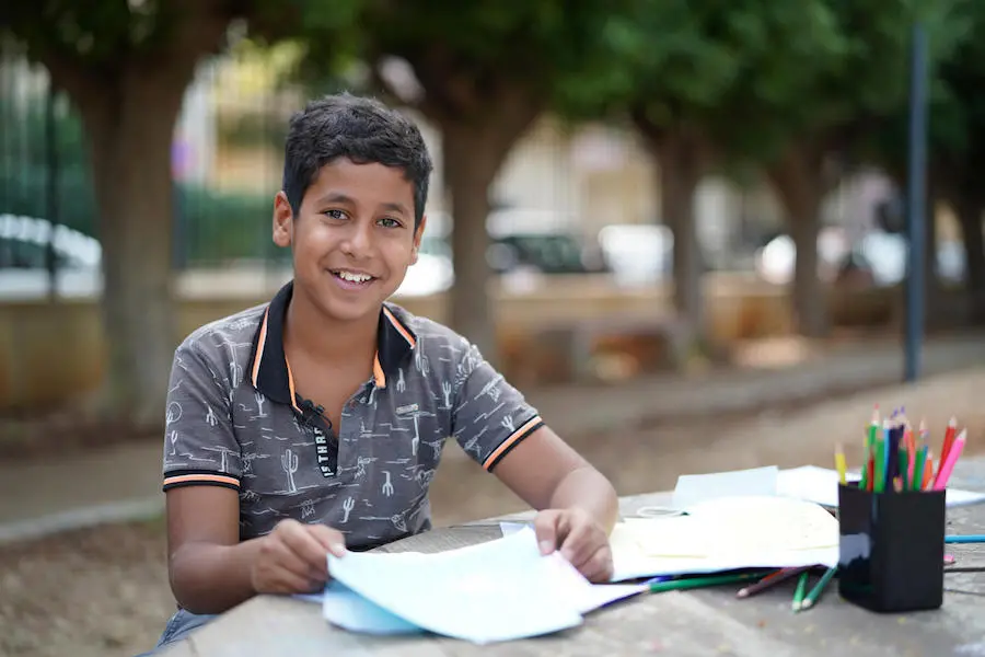 Hussein, 12, proudly shows his drawings at the UNICEF Child-Friendly Space in Beirut's Karantina Municipal Park on October 28, 2020. Hussein, 12, proudly shows his drawings at the UNICEF Child-Friendly Space in Beirut's Karantina Municipal Park on October 28, 2020.