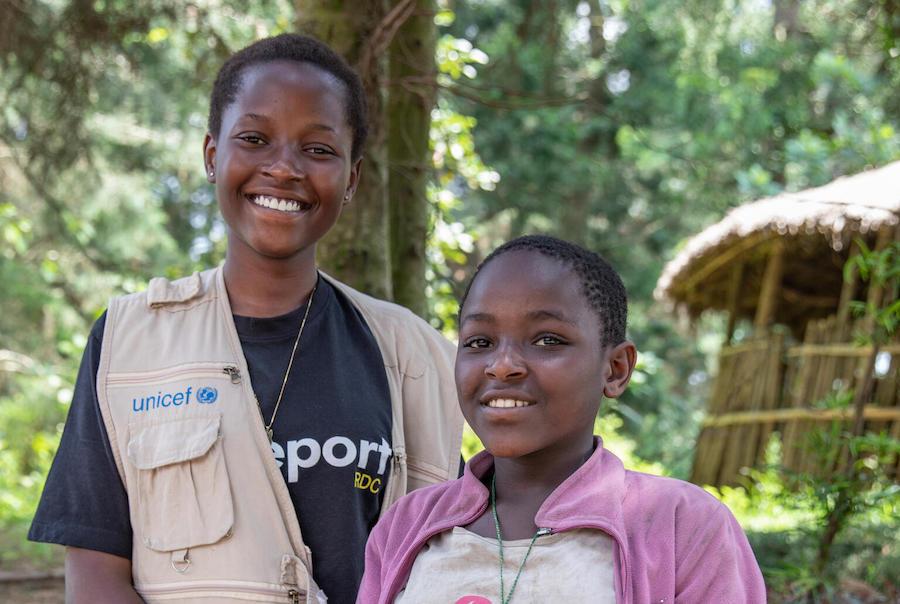 In Buhumba, DRC, UNICEF Child Reporter Ketsia, left, met with 12-year-old Prisca, who shared her concerns about her community’s routine cutting of forest trees to make charcoal, a process that contributes to deforestation and global warming. 