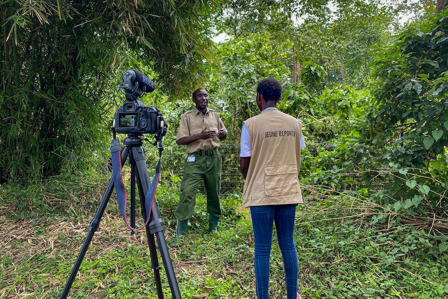A UNICEF Child Reporter interviews an eco-guard at Virunga National Park in Democratic Republic of Congo. 