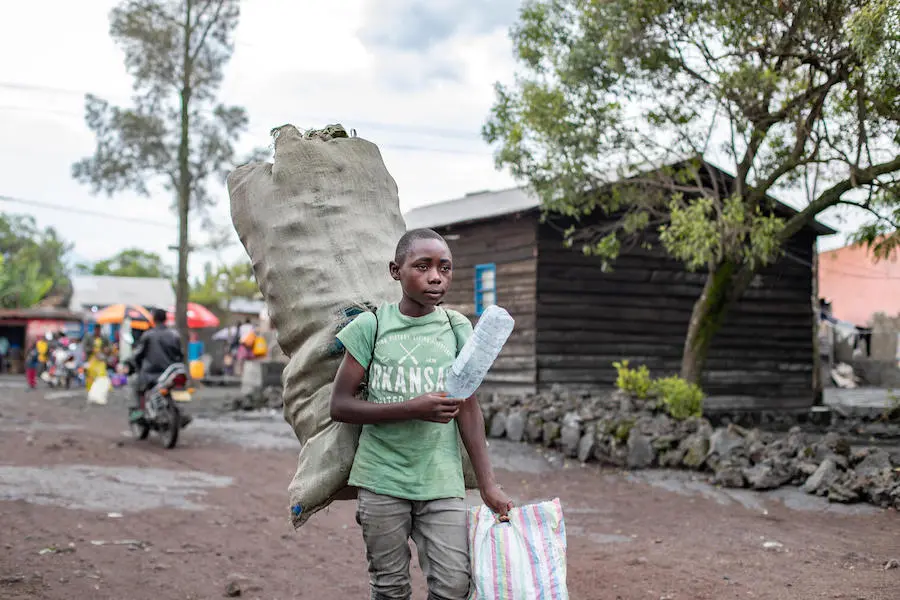 When he's not doing schoolwork, 15-year-old Destin collects and sells plastic bottles he finds in bins and rubbish heaps on the streets of Goma, the capital of North Kivu Province. When he's not doing schoolwork, 15-year-old Destin collects and sells plastic bottles he finds in bins and rubbish heaps on the streets of Goma, the capital of North Kivu Province.