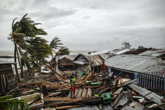 In Bilwi, Nicaragua, a child looks for scraps of wood to help his parents rebuild their house after it was destroyed by the strong winds and rains brought by Hurricane Iota in November 2020. In Bilwi, Nicaragua, a child looks for scraps of wood to help his parents rebuild their house after it was destroyed by the strong winds and rains brought by Hurricane Iota in November 2020.