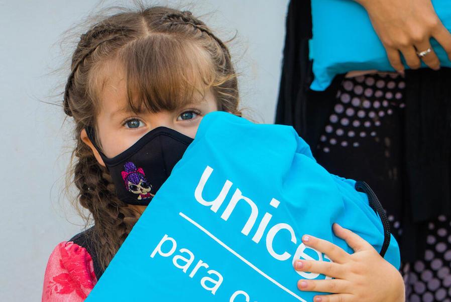 On October 26, 2020 in El Junco, Táchira State, Venezuela, Dianggelli holds a kit full of hygiene supplies distributed by UNICEF to help families protect themselves from the spread of the novel coronavirus. 