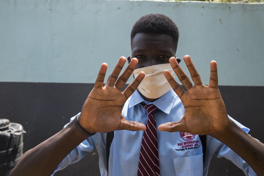 Daniel, 17, washed his hands with clean running water and soap before entering his classroom at Nile International Academy in Juba, South Sudan, in accordance with a new school rule.