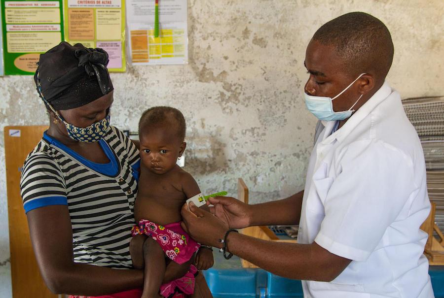 A UNICEF-trained community health worker screens 18-month-old Rosa for malnutrition in Cabo Delgado Province, Mozambique on December 3, 2020.