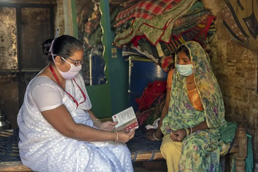 Heena Joshi 48 – year – old UNICEF health worker (Left) on routine home visits to check on Aruna Dodiyar 25 – year – old (Right) with her 2nd pregnancy to check the hemoglobin. Heena Joshi 48 – year – old UNICEF health worker (Left) on routine home visits to check on Aruna Dodiyar 25 – year – old (Right) with her 2nd pregnancy to check the hemoglobin.