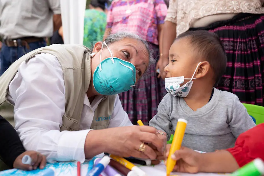 UNICEF's Regional Director for Latin America and the Caribbean, Jean Gough, colors with children during an activity at a school in Campur Alta Verapaz, in Guatemala. 