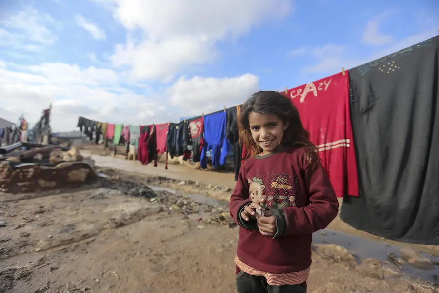 On 19 January 2021, a child stands in front of clothes hanging on a drying line in Kafr Losin Camp in northwest Syrian Arab Republic. On 19 January 2021, a child stands in front of clothes hanging on a drying line in Kafr Losin Camp in northwest Syrian Arab Republic.