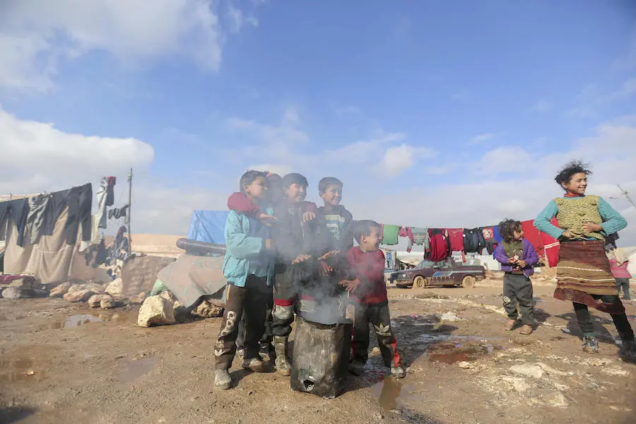 On 19 January 2021, children warm their hands by a fire in Kafr Losin Camp in northwest Syrian Arab Republic. On 19 January 2021, children warm their hands by a fire in Kafr Losin Camp in northwest Syrian Arab Republic.