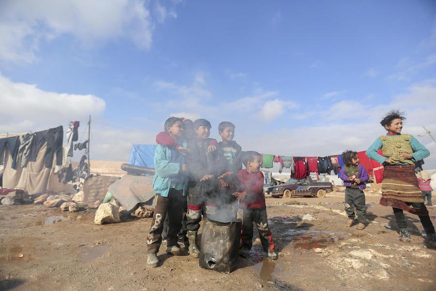 On 19 January 2021, children warm their hands by a fire in Kafr Losin Camp in northwest Syrian Arab Republic. 