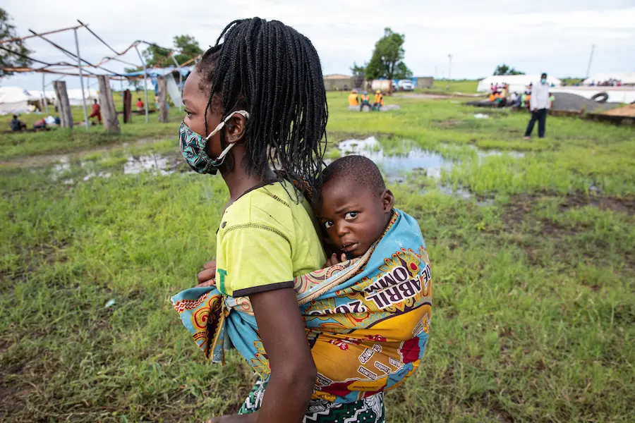 A mother and child affected by Cyclone Eloise arrive at a relocation center supported by UNICEF some 50 miles outside of the port city of Beira, Sofala province, Mozambique. A mother and child affected by Cyclone Eloise arrive at a relocation center supported by UNICEF some 50 miles outside of the port city of Beira, Sofala province, Mozambique.