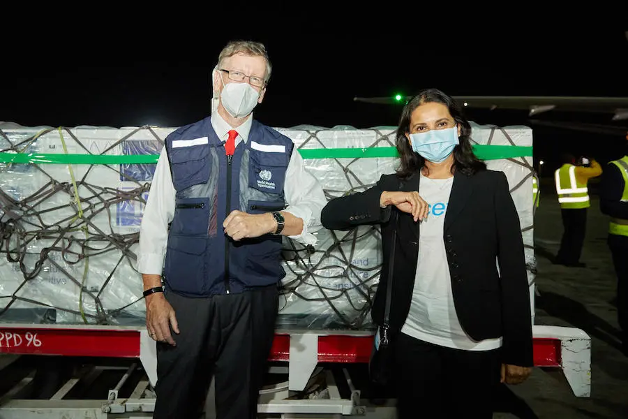 On 3 March 2021, WHO Kenya Representative Rudi Eggers (left) and UNICEF Kenya Representative Maniza Zaman (right) receive Kenya's first COVID-19 vaccines from the COVAX facility at Jomo Kenyatta International Airport in Nairobi. On 3 March 2021, WHO Kenya Representative Rudi Eggers (left) and UNICEF Kenya Representative Maniza Zaman (right) receive Kenya's first COVID-19 vaccines from the COVAX facility at Jomo Kenyatta International Airport in Nairobi.
