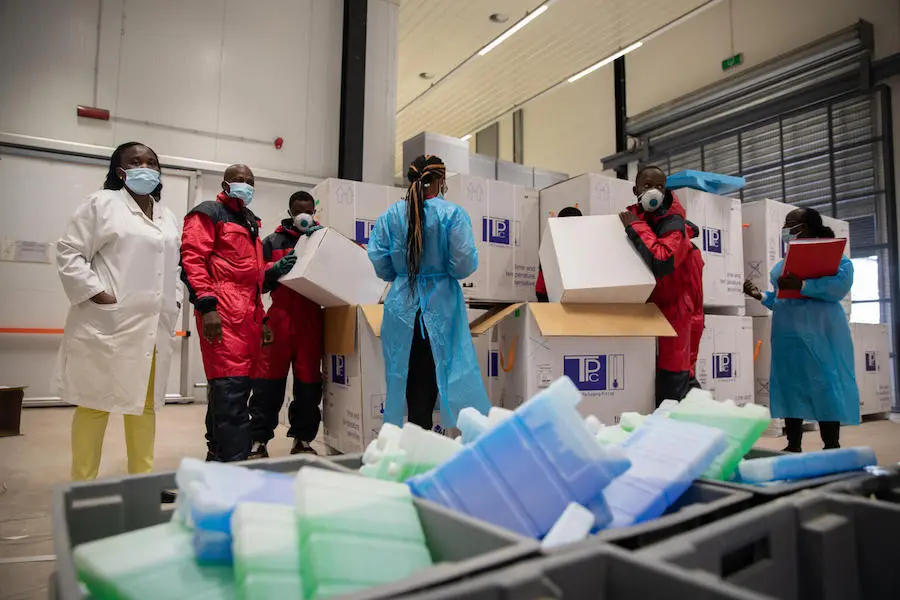 Cold chain staff unpack COVID-19 vaccines for storage in the cold room of the vaccine storage warehouse, Kinkole commune, Kinshasa, DRC on March 2, 2021. Cold chain staff unpack COVID-19 vaccines for storage in the cold room of the vaccine storage warehouse, Kinkole commune, Kinshasa, DRC on March 2, 2021.