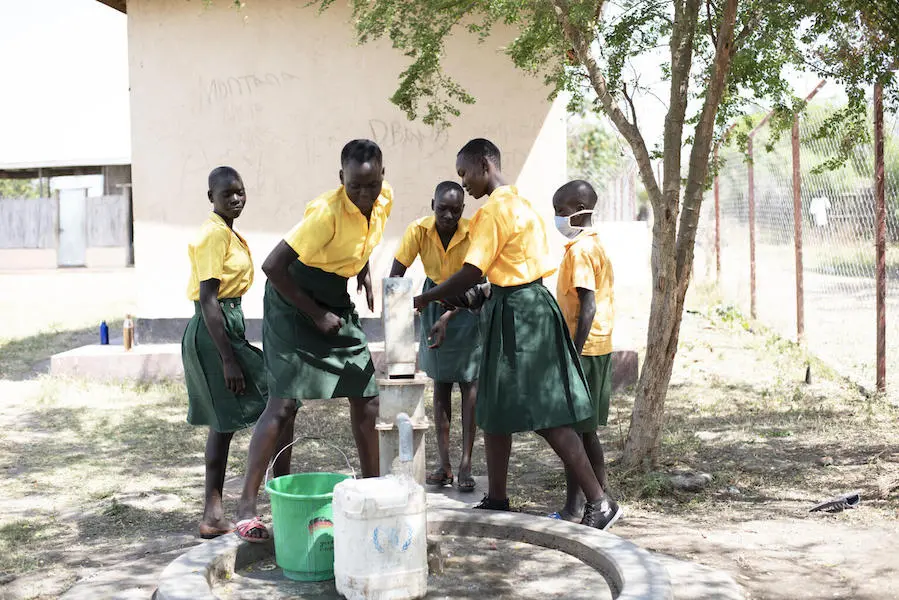 At Dumak Primary School in Torit, South Sudan on February 2, 2021, students fill buckets with safe water from a borehole rehabilitated by UNICEF and partners. At Dumak Primary School in Torit, South Sudan on February 2, 2021, students fill buckets with safe water from a borehole rehabilitated by UNICEF and partners.