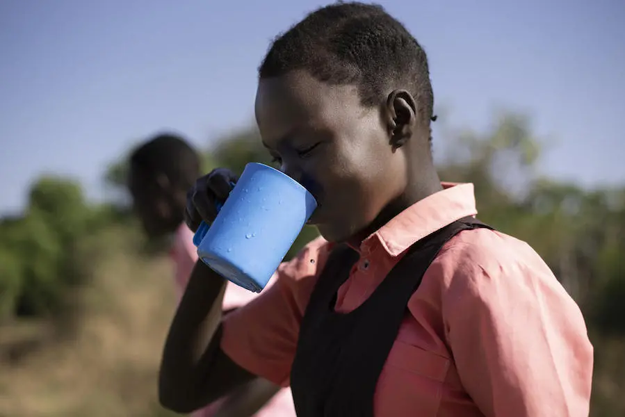 Keziah, 14, drinks water from the borehole at AIC Nursery and Primary School in Torit, South Sudan in February 2021. Keziah, 14, drinks water from the borehole at AIC Nursery and Primary School in Torit, South Sudan in February 2021.