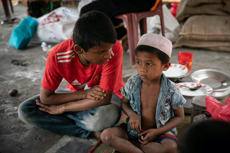 Mohammad Faisal, 18, comforts a younger Rohingya refugee while the child’s family goes for help after their home was lost to the fire that devastated the Balukhali area of the Rohingya refugee camps in Cox’s Bazar, Bangladesh.